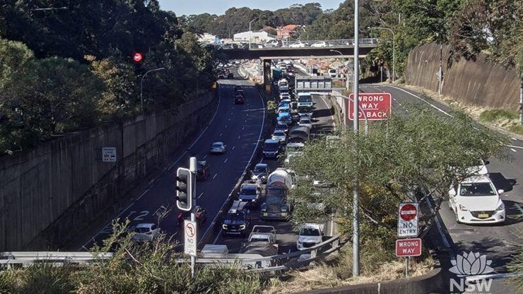 Drivers are urged to avoid the Gore Hill Freeway following a crash involving a car and a motorcycle.